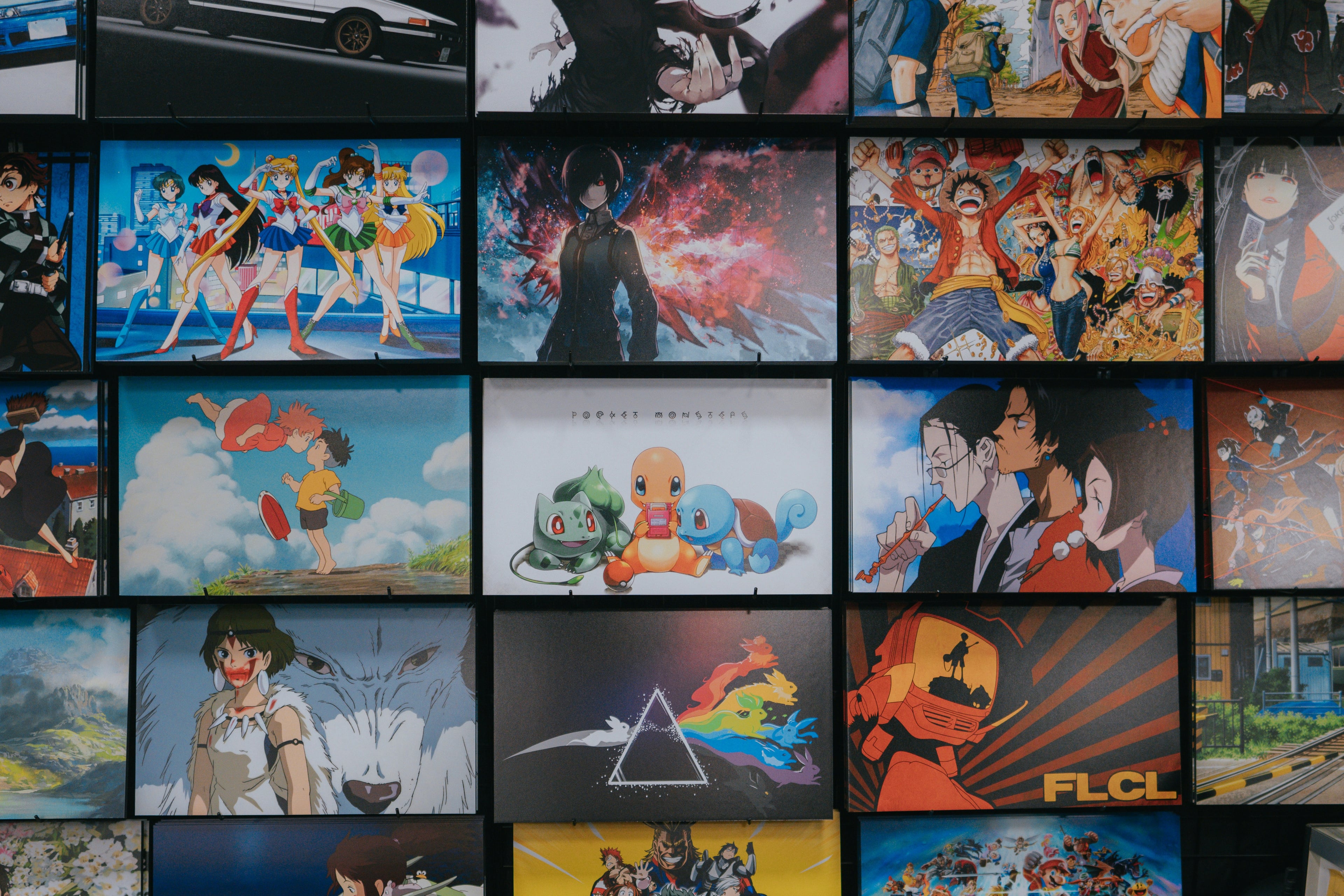 Wall of anime posters including Sailor Moon, One Piece, and Studio Ghibli art